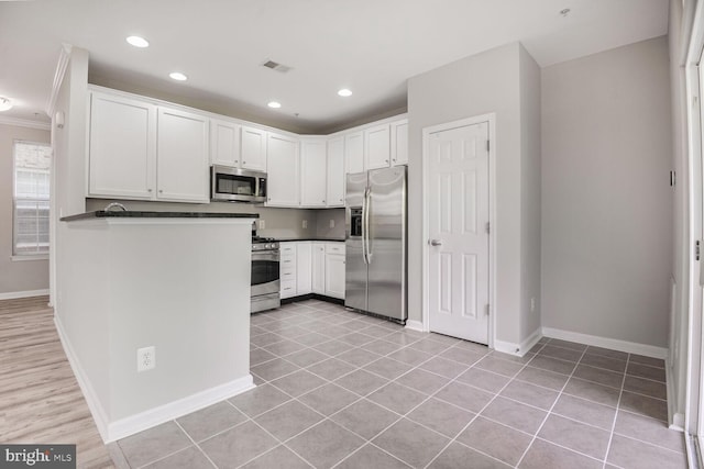 43415 Madison Renee Ter Unit 120, Ashburn, VA 20147 - kitchen featuring stainless steel appliances, dark countertops, baseboards, white cabinets, and recessed lighting