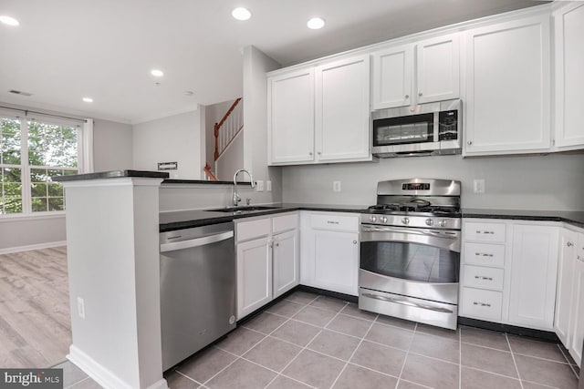 43415 Madison Renee Ter Unit 120, Ashburn, VA 20147 - kitchen featuring stainless steel appliances, a sink, dark countertops, white cabinetry, and recessed lighting