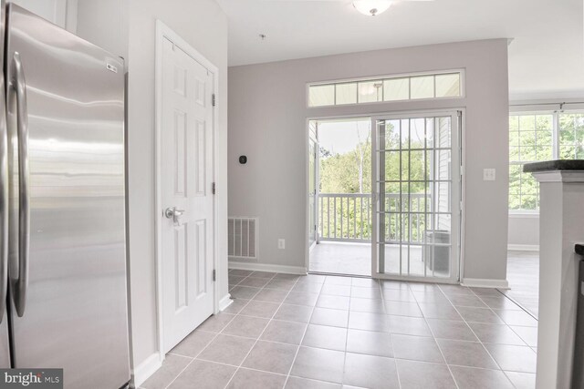 43415 Madison Renee Ter Unit 120, Ashburn, VA 20147 - doorway to outside featuring baseboards and tile patterned floors