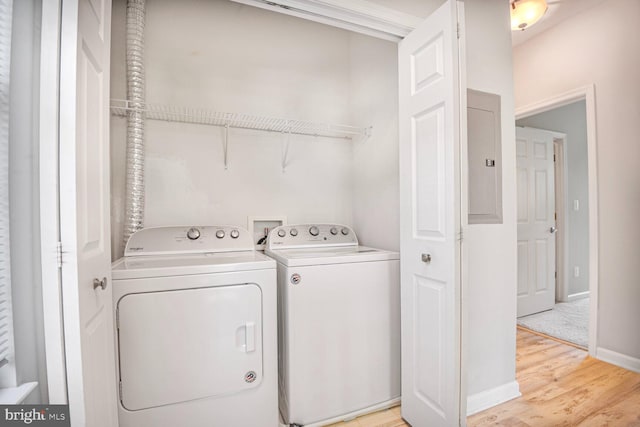 43415 Madison Renee Ter Unit 120, Ashburn, VA 20147 - laundry room featuring washer and clothes dryer, electric panel, light wood-style flooring, and baseboards