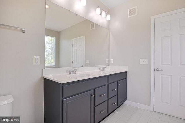 43415 Madison Renee Ter Unit 120, Ashburn, VA 20147 - bathroom with double vanity, toilet, tile patterned floors, and baseboards