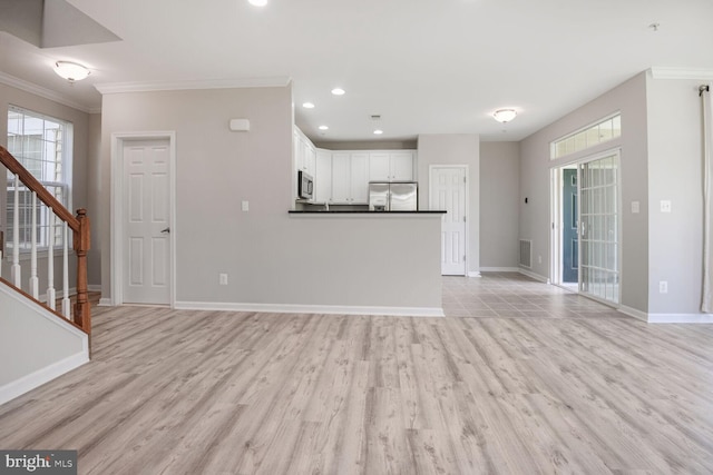 43415 Madison Renee Ter Unit 120, Ashburn, VA 20147 - unfurnished living room with ornamental molding, healthy amount of natural light, baseboards, light wood-style flooring, and recessed lighting