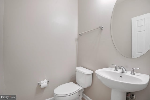 43415 Madison Renee Ter Unit 120, Ashburn, VA 20147 - bathroom with toilet, baseboards, and a sink