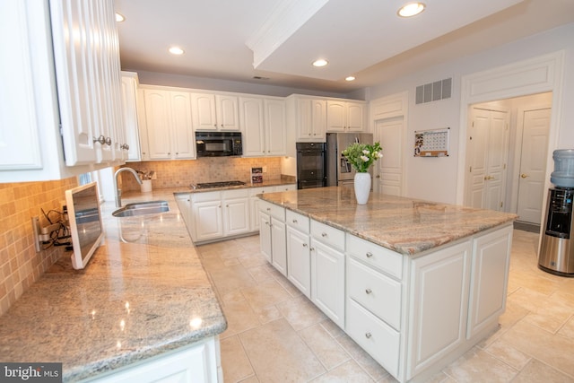 32 Eagleton Farm Rd, Newtown, PA 18940 - kitchen featuring a sink, black appliances, tasteful backsplash, a center island, and white cabinetry