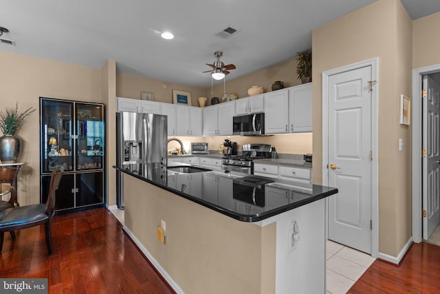 4208 Knox Ct Unit 4208, Warwick, PA 18974 - kitchen featuring appliances with stainless steel finishes, a sink, white cabinets, dark countertops, and a center island with sink