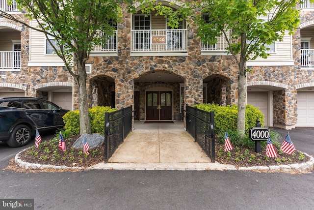 4208 Knox Ct Unit 4208, Warwick, PA 18974 - view of exterior entry with stone siding, french doors, a balcony, and a garage