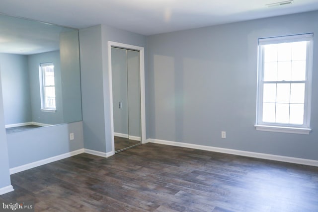 1000 Country Club Rd Unit 8, York, PA 17403 - unfurnished bedroom with dark wood finished floors, a closet, and baseboards