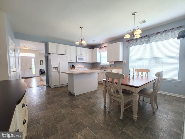 1513 Turtle Creek Ln, Quakertown, PA 18951 - dining room with a chandelier, baseboards, and dark stone finish flooring