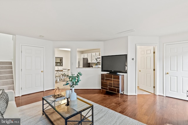 9217 Cardinal Forest Ln Unit 30, Lorton, VA 22079 - living area featuring wood finished floors, stairs, and baseboards