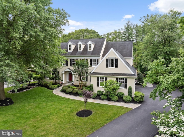 704 Turnbridge Rd, Wayne, PA 19087 - view of front of home with stucco siding, a front yard, and asphalt driveway