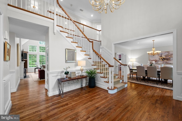 704 Turnbridge Rd, Wayne, PA 19087 - foyer entrance featuring a chandelier, stairs, crown molding, wood finished floors, and a towering ceiling