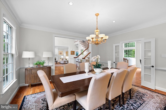 704 Turnbridge Rd, Wayne, PA 19087 - dining room featuring a chandelier, ornamental molding, light wood finished floors, baseboards, and stairway
