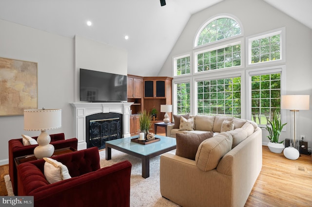 704 Turnbridge Rd, Wayne, PA 19087 - living room featuring a glass covered fireplace, high vaulted ceiling, wood finished floors, recessed lighting, and baseboards