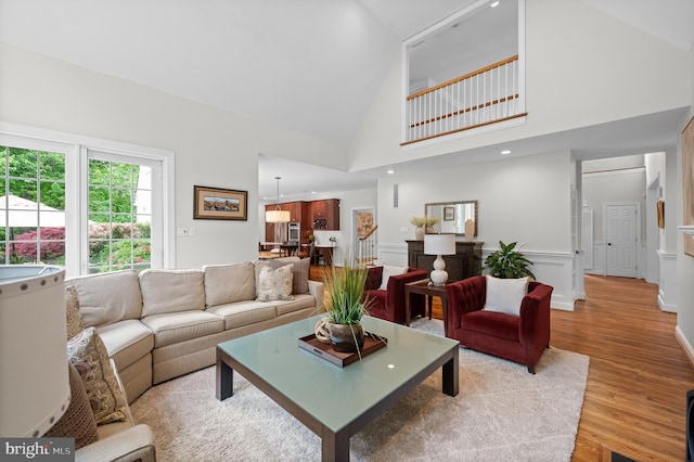 704 Turnbridge Rd, Wayne, PA 19087 - living area featuring light wood finished floors, high vaulted ceiling, and wainscoting