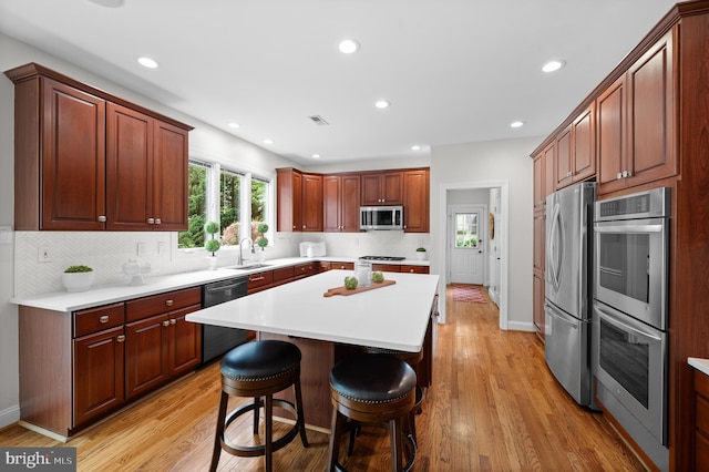 704 Turnbridge Rd, Wayne, PA 19087 - kitchen featuring stainless steel appliances, a sink, light countertops, recessed lighting, and light wood finished floors