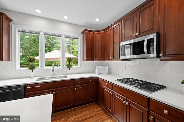 704 Turnbridge Rd, Wayne, PA 19087 - kitchen with stainless steel appliances, a sink, light countertops, dark wood-style floors, and decorative backsplash