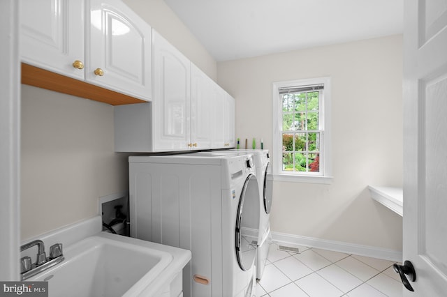 704 Turnbridge Rd, Wayne, PA 19087 - laundry room with cabinet space, washer and dryer, light tile patterned floors, and baseboards