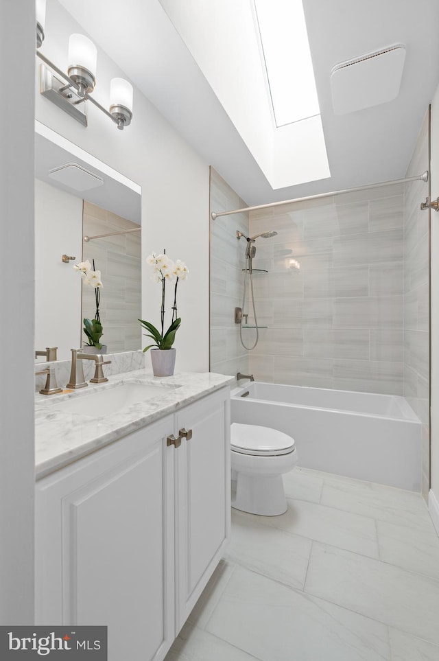 704 Turnbridge Rd, Wayne, PA 19087 - bathroom featuring vanity, toilet, bathing tub / shower combination, a skylight, and marble look tiles