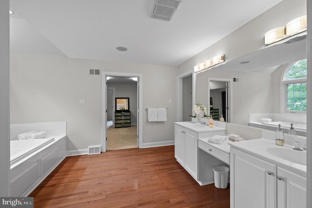 704 Turnbridge Rd, Wayne, PA 19087 - bathroom featuring vanity, wood finished floors, and a bath
