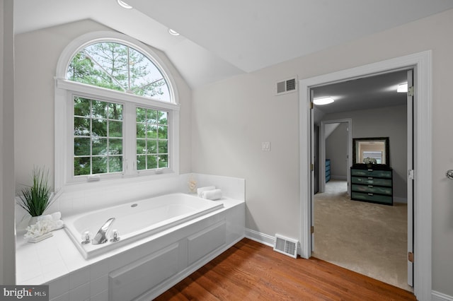 704 Turnbridge Rd, Wayne, PA 19087 - bathroom with lofted ceiling, healthy amount of natural light, a bath, baseboards, and wood finished floors