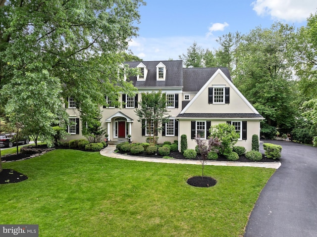 704 Turnbridge Rd, Wayne, PA 19087 - view of front of home with stucco siding, a front lawn, and a shingled roof