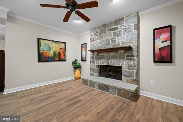 704 Turnbridge Rd, Wayne, PA 19087 - unfurnished living room featuring a stone fireplace, a ceiling fan, wood finished floors, baseboards, and crown molding