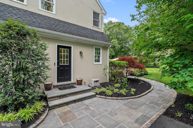 704 Turnbridge Rd, Wayne, PA 19087 - entrance to property with roof with shingles, stucco siding, and a patio area