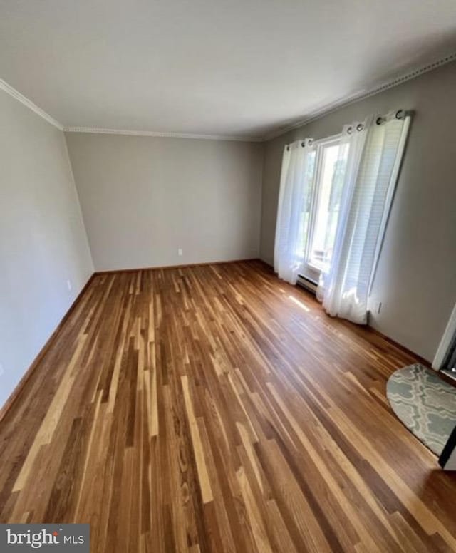 230 Eisenhower Dr, Orwigsburg, PA 17961 - empty room featuring wood finished floors, ornamental molding, and a baseboard radiator