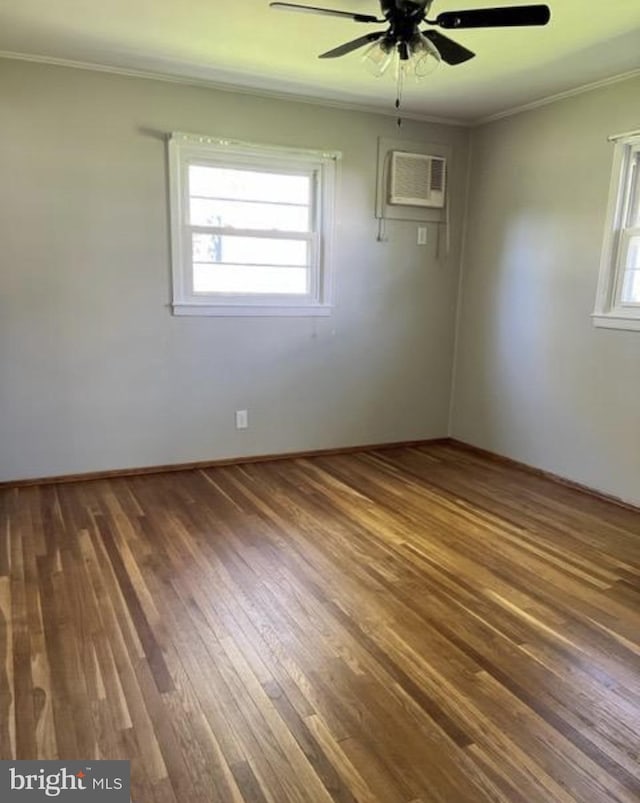230 Eisenhower Dr, Orwigsburg, PA 17961 - spare room with a wall unit AC, crown molding, a ceiling fan, wood finished floors, and baseboards