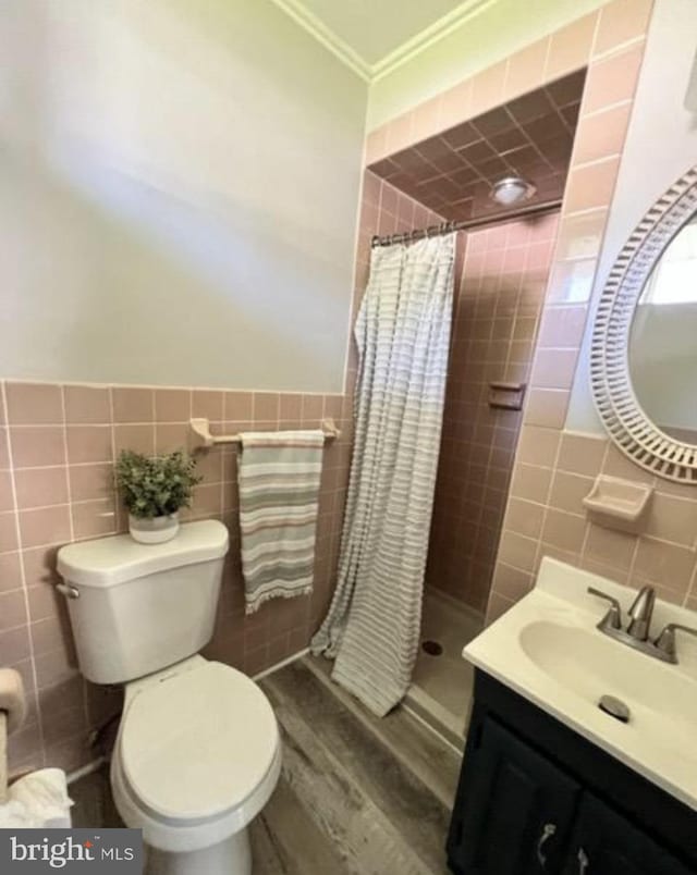 230 Eisenhower Dr, Orwigsburg, PA 17961 - full bath with tile walls, toilet, a shower stall, vanity, and wood finished floors