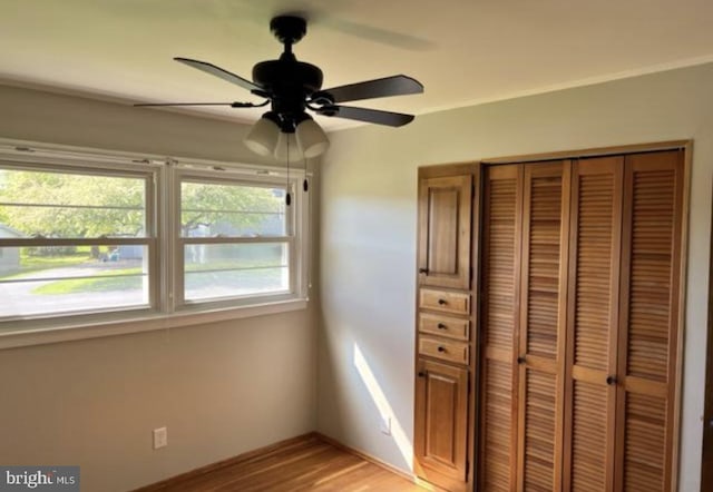 230 Eisenhower Dr, Orwigsburg, PA 17961 - unfurnished bedroom with a closet, light wood-type flooring, baseboards, and a ceiling fan