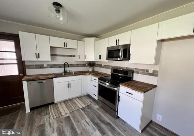 230 Eisenhower Dr, Orwigsburg, PA 17961 - kitchen featuring stainless steel appliances, a sink, butcher block counters, backsplash, and dark wood-style flooring