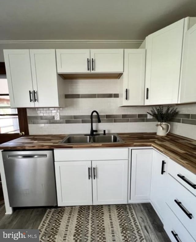 230 Eisenhower Dr, Orwigsburg, PA 17961 - kitchen with butcher block countertops, stainless steel dishwasher, dark wood finished floors, a sink, and white cabinets