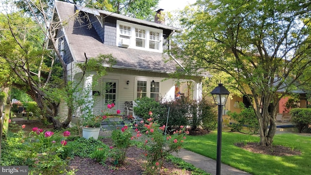 5463 Nebraska Ave NW, Washington, DC 20015 - view of front of house with a front yard, a chimney, roof with shingles, and cooling unit
