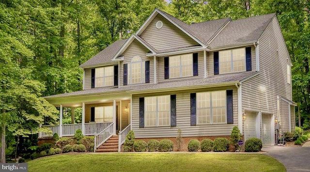 9109 Snowy Egret Ct, Spotsylvania, VA 22553 - view of front of home with a porch, an attached garage, asphalt driveway, a front yard, and a shingled roof