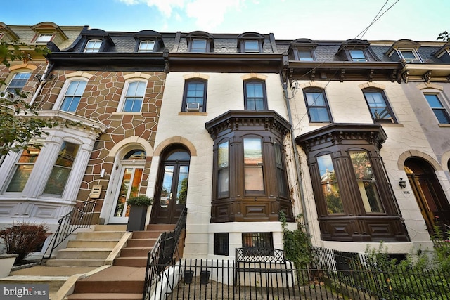 743 N 26th St, Philadelphia, PA 19130 - view of front facade with mansard roof, a fenced front yard, a high end roof, and french doors