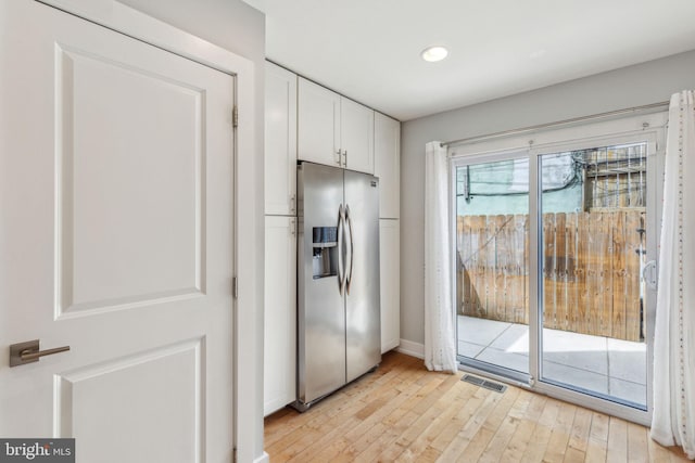 939 Sigel St, Philadelphia, PA 19148 - kitchen with stainless steel fridge with ice dispenser, white cabinetry, light wood-type flooring, baseboards, and recessed lighting