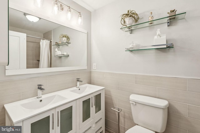 939 Sigel St, Philadelphia, PA 19148 - full bathroom with double vanity, toilet, curtained shower, tile walls, and wainscoting