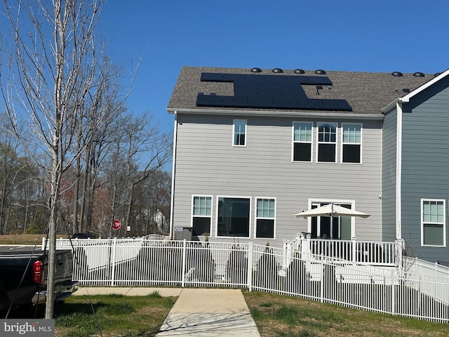 18010 Woods Overlook Dr, Dumfries, VA 22026 - rear view of house with solar panels and a shingled roof