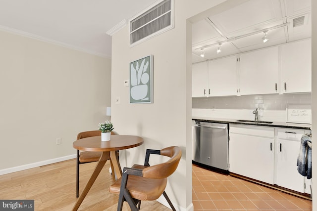 1801 Park Rd NW Unit 2, Washington, DC 20010 - kitchen with stainless steel dishwasher, a sink, ornamental molding, white cabinets, and tasteful backsplash