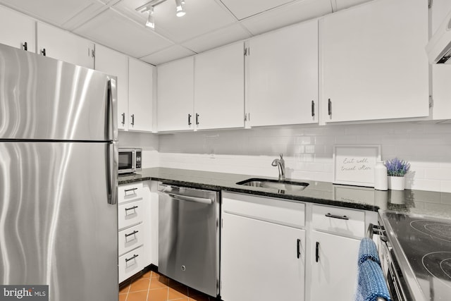 1801 Park Rd NW Unit 2, Washington, DC 20010 - kitchen featuring appliances with stainless steel finishes, a sink, white cabinets, dark stone counters, and backsplash