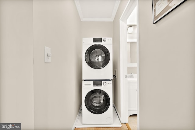 1801 Park Rd NW Unit 2, Washington, DC 20010 - laundry area with stacked washing machine and dryer, crown molding, a sink, and wood finished floors
