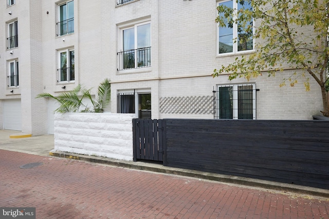 1801 Park Rd NW Unit 2, Washington, DC 20010 - view of side of home featuring brick siding and a gate