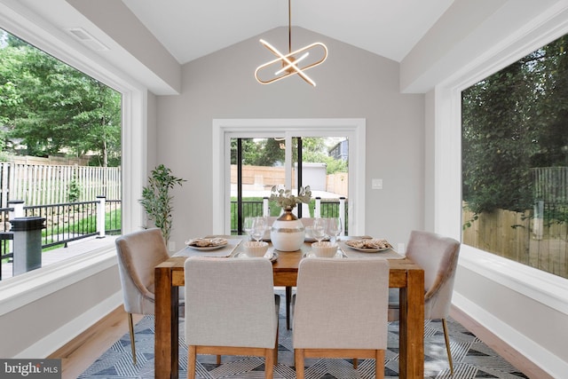 1427 Jackson St NE, Washington, DC 20017 - dining area featuring healthy amount of natural light, wood finished floors, a chandelier, lofted ceiling, and baseboards