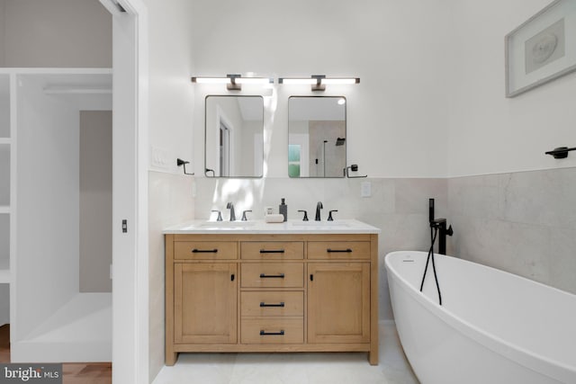 1427 Jackson St NE, Washington, DC 20017 - full bathroom with a soaking tub, double vanity, a shower, and tile walls