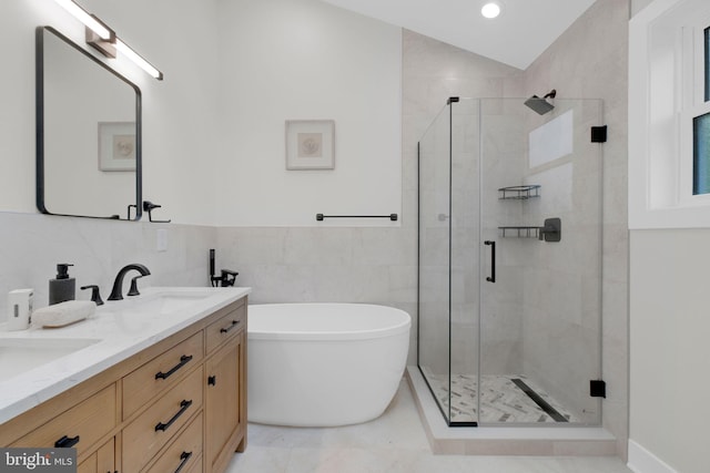 1427 Jackson St NE, Washington, DC 20017 - full bath with a soaking tub, a stall shower, double vanity, tile walls, and recessed lighting