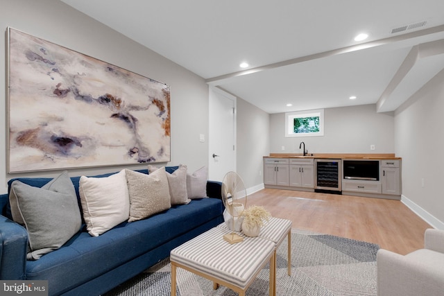 1427 Jackson St NE, Washington, DC 20017 - living room with beverage cooler, wet bar, light wood-style floors, baseboards, and recessed lighting