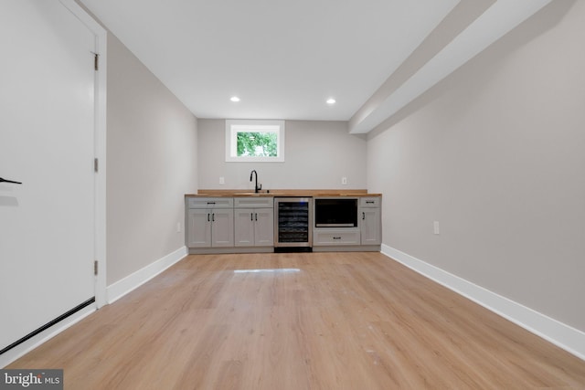 1427 Jackson St NE, Washington, DC 20017 - bar with wine cooler, a sink, light wood-style flooring, baseboards, and recessed lighting