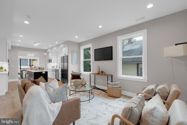 1427 Jackson St NE, Washington, DC 20017 - living room with recessed lighting, healthy amount of natural light, light wood finished floors, and baseboards