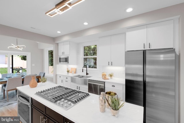 1427 Jackson St NE, Washington, DC 20017 - kitchen with appliances with stainless steel finishes, a sink, light countertops, white cabinetry, and recessed lighting